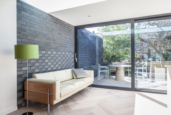 doma architects woven brick house roundhay- view of wall that continues inside